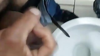 Two lads are having fun in the toilet.