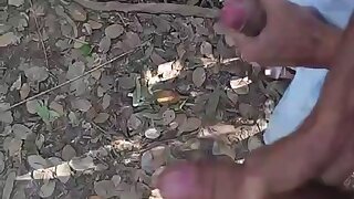 Guy jerking off each other and both cumming in cruising park