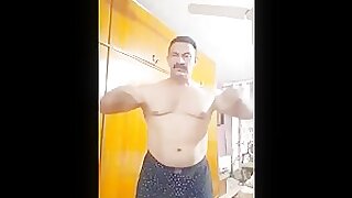 Pakistani men flex muscle