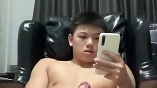 A cute boy jerks off and shoots his load