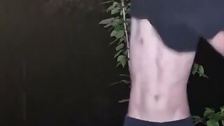 Young plugged guy strips outdoors