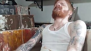 Scruffy, tattooed redhead